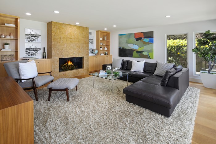 Living room with fireplace, sofa, and armchair