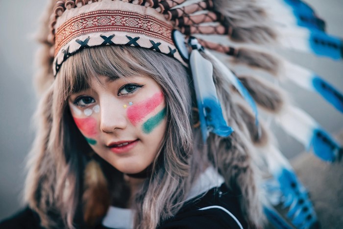 Girl with Native American headdress and face paint