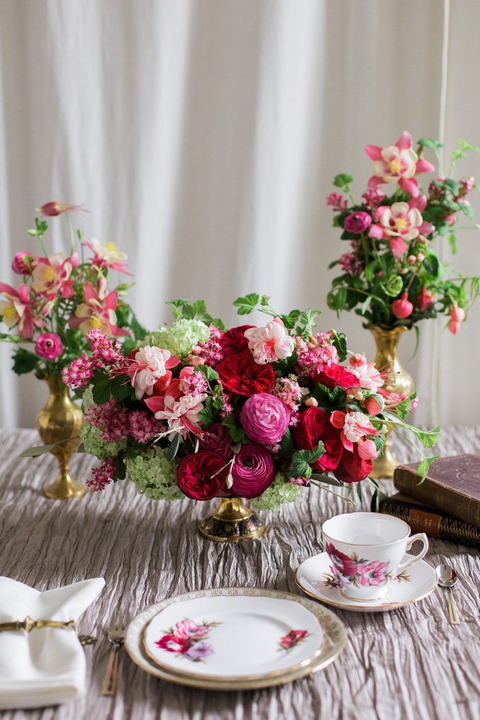 Floral arrangement with teacup and plate
