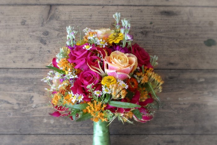 Colorful bridal bouquet on wooden background