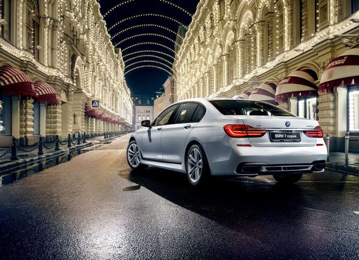 White BMW 7 Series G12 Sedan on a Wet Street at Night