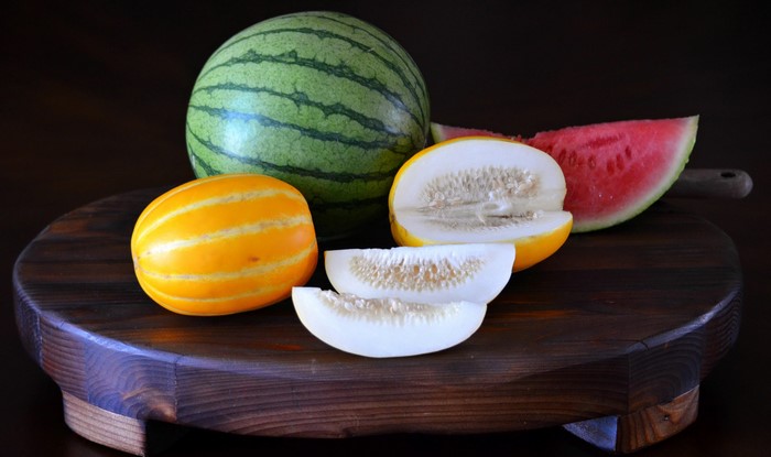 Watermelon and melons on a wooden board