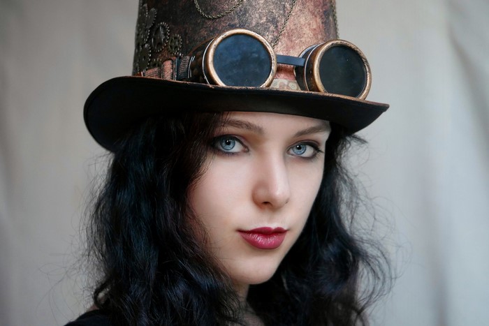 Steampunk girl with goggles and top hat