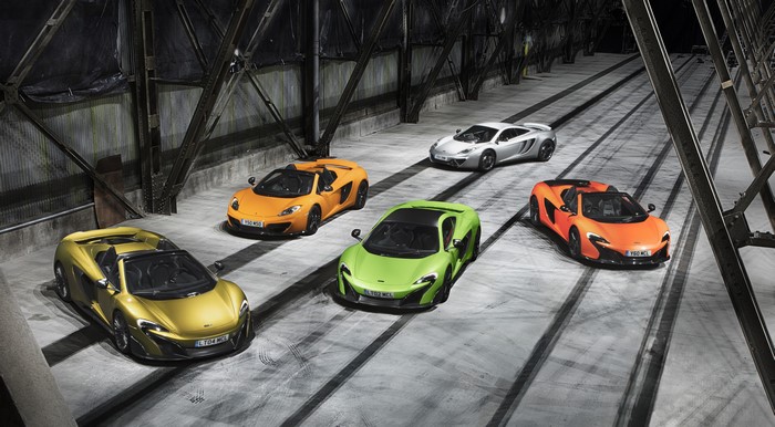 Five McLaren Sports Cars in a Warehouse