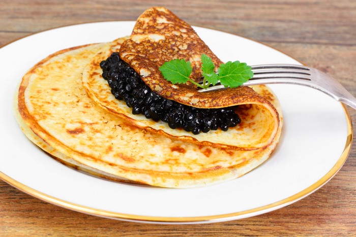Pancakes with Caviar and Mint on a Plate
