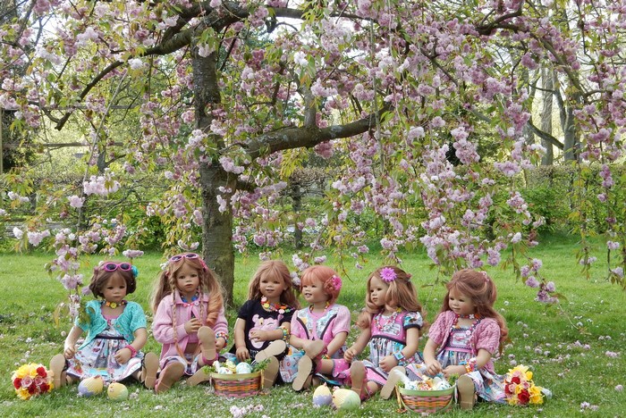 Dolls in a park with flowering trees in Germany