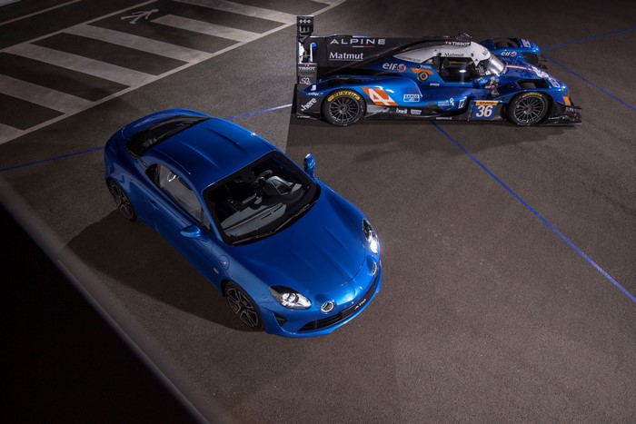 Two blue Alpine cars on a track