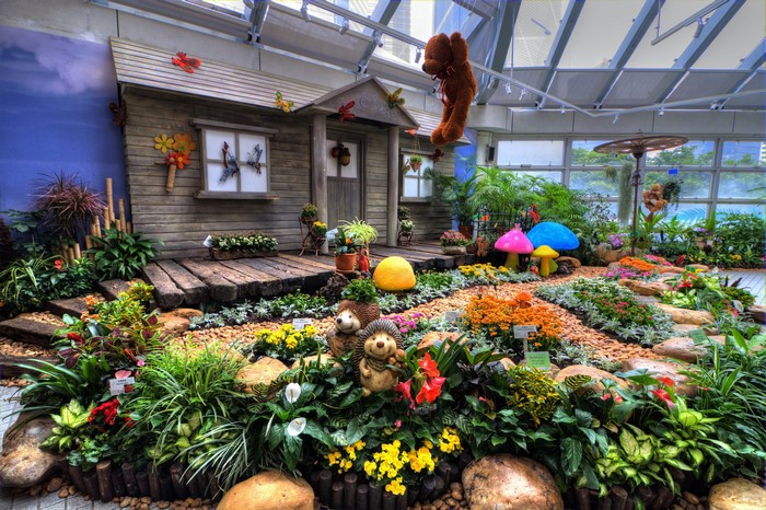 Garden display with a miniature house and hedgehogs