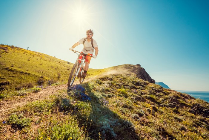 Man riding a mountain bike on a sunny trail