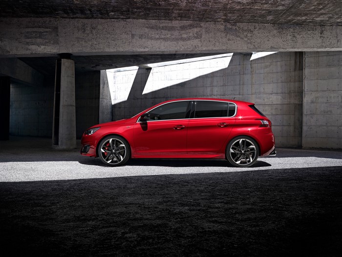 Red Peugeot 308 GTi parked under concrete structure