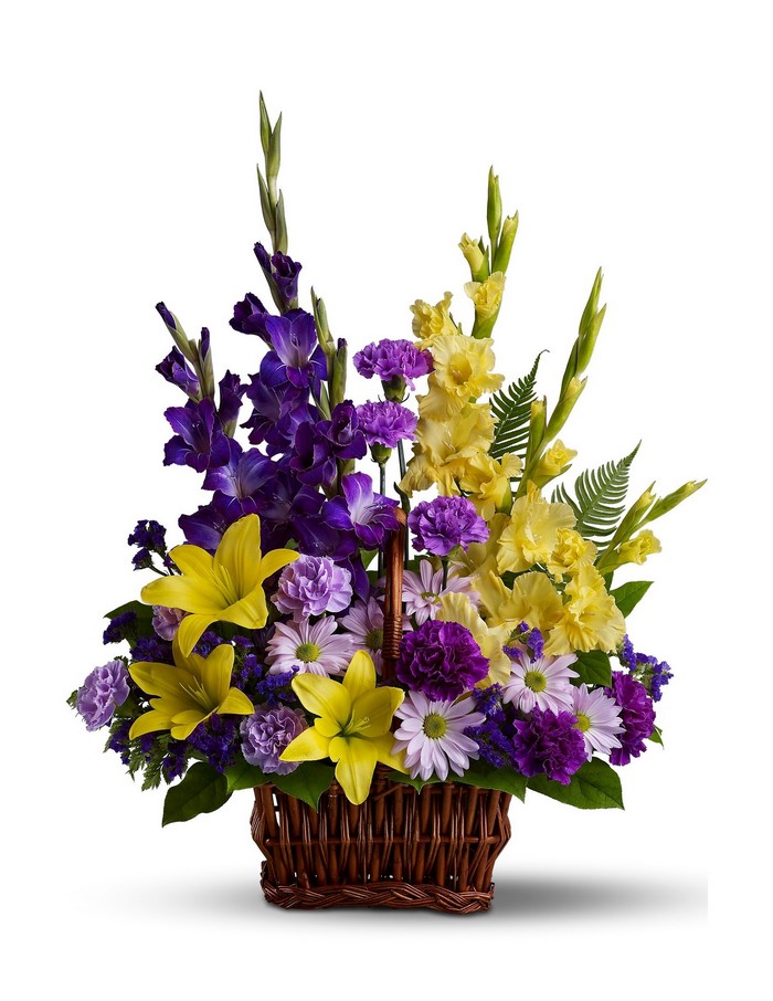 Purple and yellow gladiolus and lily flower arrangement in a basket