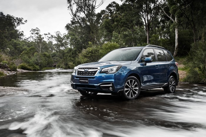 Blue Subaru Forester driving through a stream
