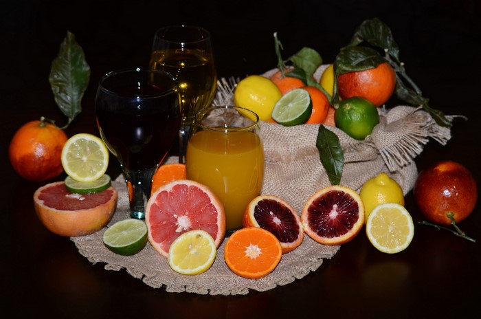 Citrus fruits and juices with wine glasses