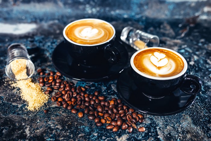 Two Cappuccinos with Coffee Beans and Sugar