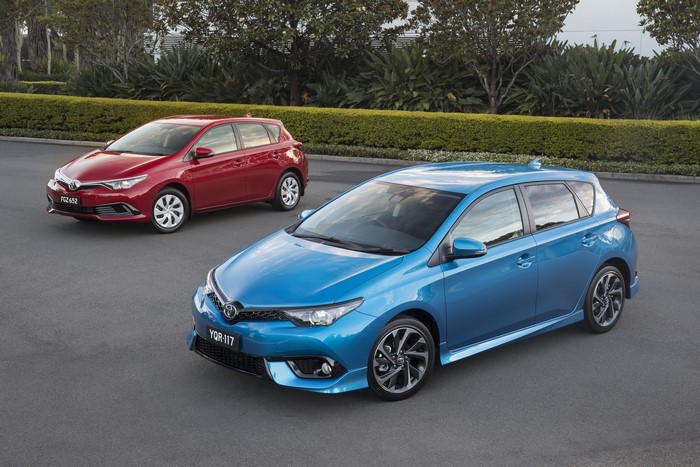 Two Toyota Corolla Hatchbacks, one red and one blue