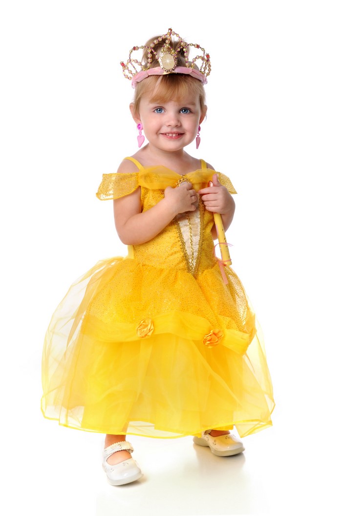 Little girl in a yellow princess dress and crown