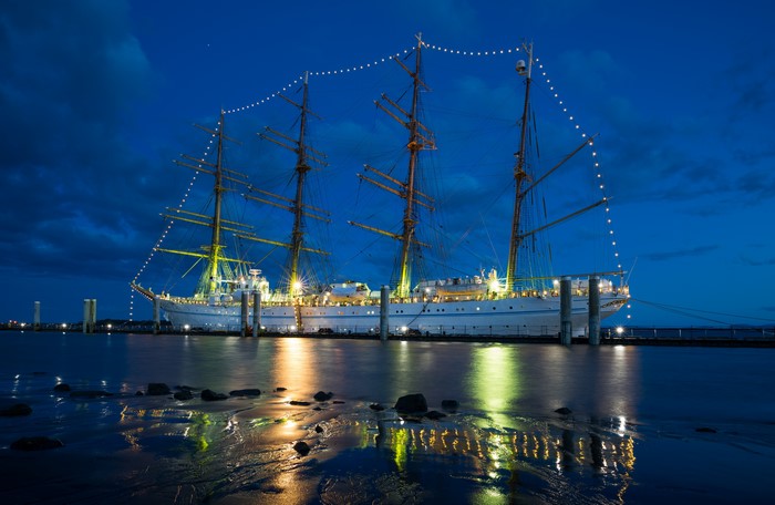 Tall Ship Illuminated at Night with Fairy Lights