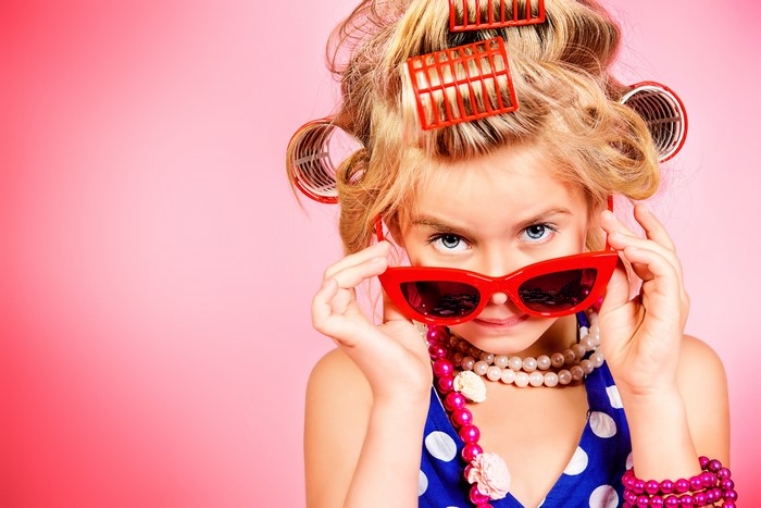 Girl with curlers and sunglasses