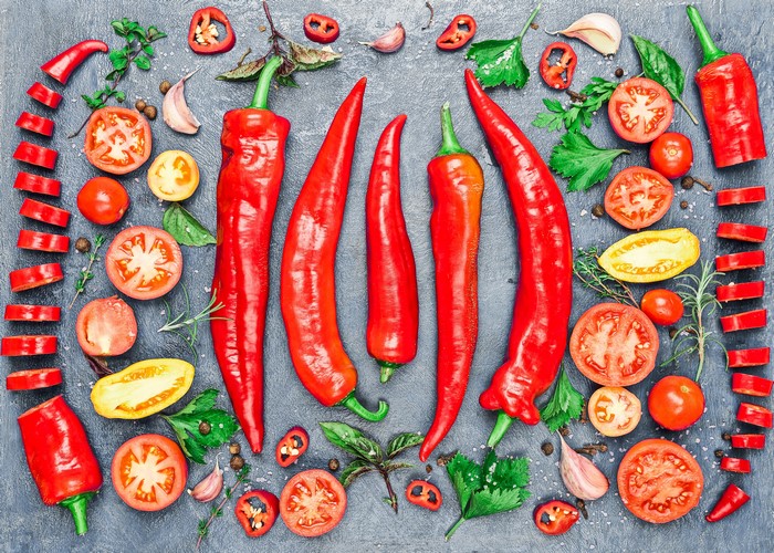 Tomatoes, Garlic, and Chili Peppers on a Dark Surface