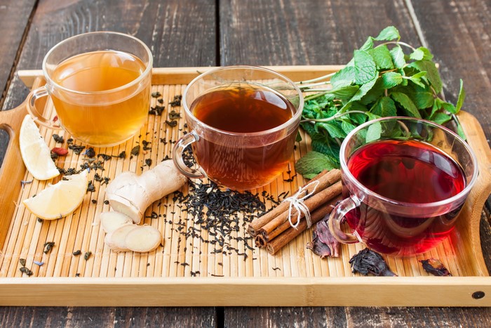 Three cups of tea with ginger, lemon, mint, and cinnamon