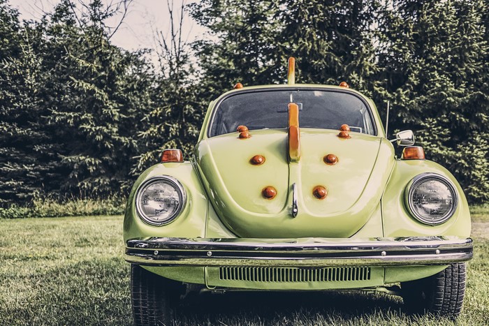 Green Volkswagen Beetle with orange accents