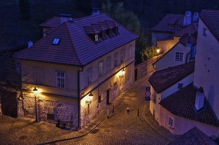 Prague street at night with houses and street lights
