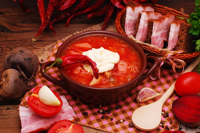 Borscht soup with bacon, bread, and vegetables