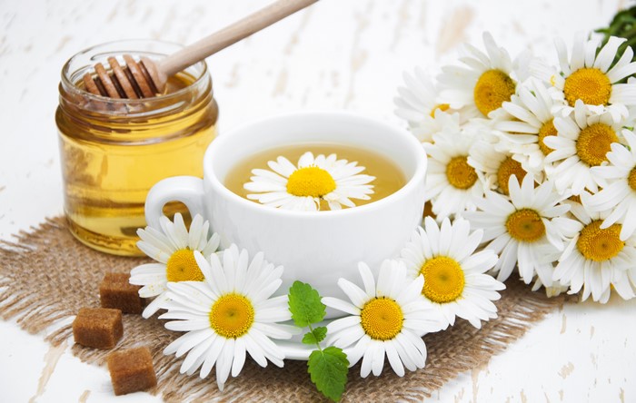 Chamomile tea with honey and daisies