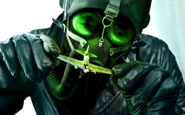 Person in gas mask holding toy airplane