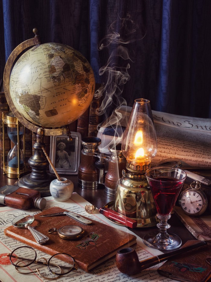 Vintage desk with globe, lamp, and books