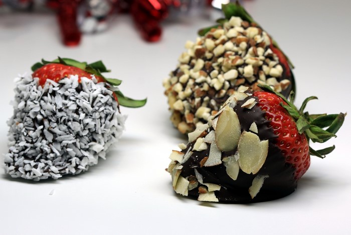 Chocolate covered strawberries with nuts and coconut