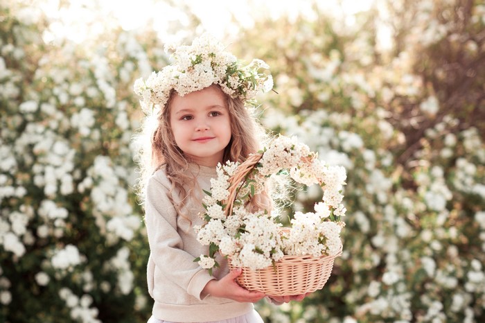 Little girl with flower crown and basket