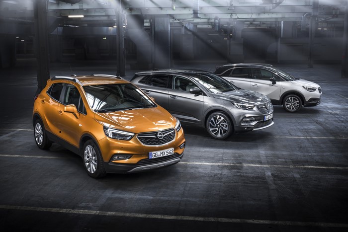 Three Opel cars in a warehouse