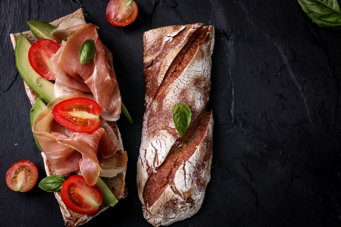Prosciutto and avocado sandwich with tomatoes and basil