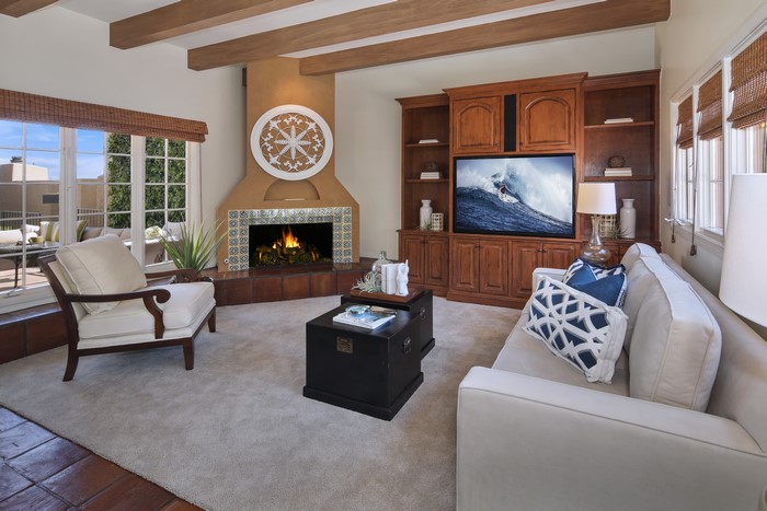 Living room with fireplace, sofa, and armchair
