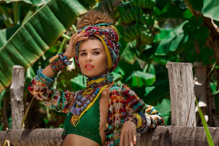 Woman with colorful headwrap and jewelry