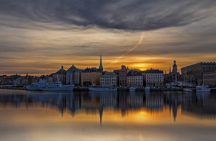Stockholm waterfront at sunset with reflections
