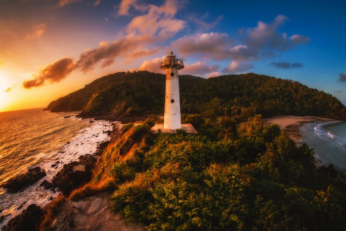 Lighthouse on a tropical coast at sunset, Thailand