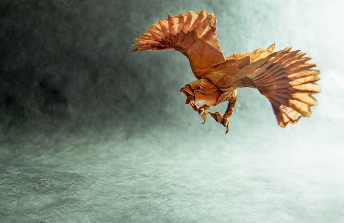 Origami bird in flight