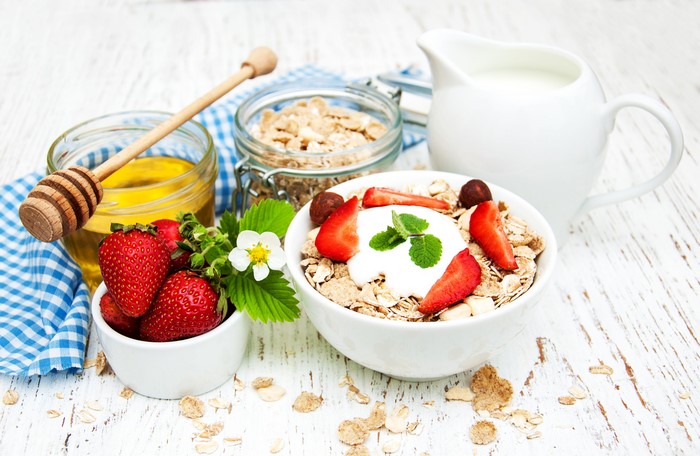 Muesli with strawberries, honey, and milk
