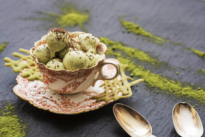 Matcha ice cream in a teacup with chocolate shavings