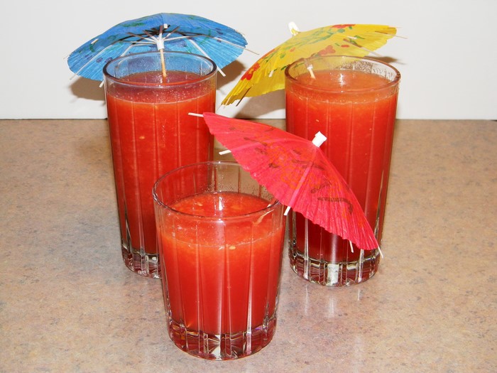 Three glasses of tomato juice with umbrellas