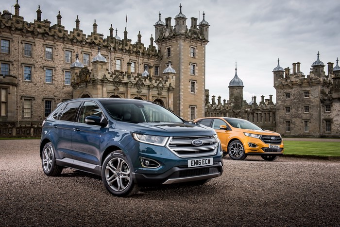 Two Ford Edge cars in front of a castle