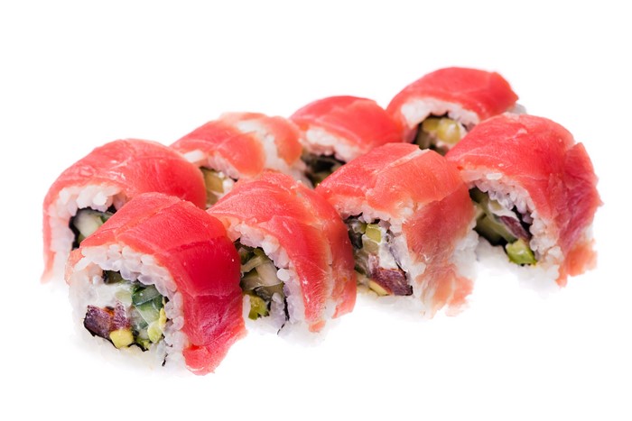 Sushi rolls with tuna and vegetables on a white background