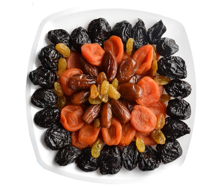 Assortment of dried fruits on a white plate
