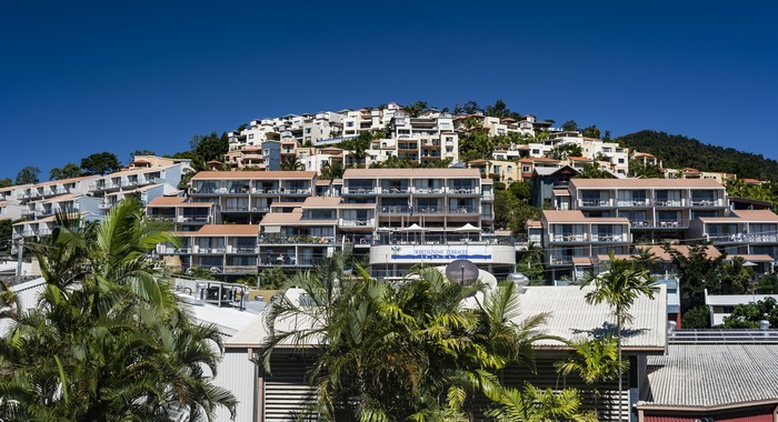 Whitsunday Terraces resort on a hillside with palm trees