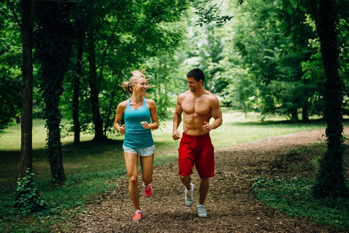 Man and woman running in a forest