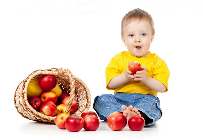 Baby boy with basket of apples