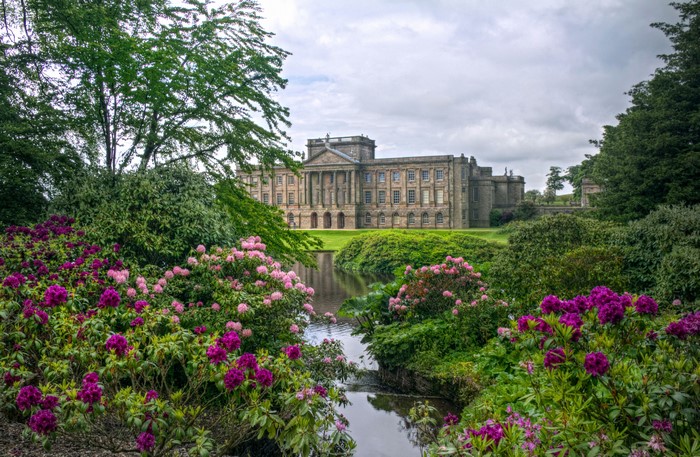 Lyme Park house with rhododendrons and pond in England