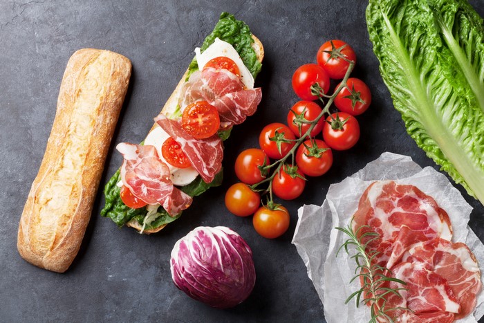 Sandwich with prosciutto, mozzarella, tomatoes, and lettuce